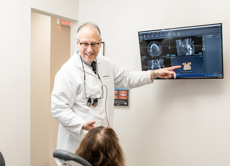 Dr. Frank Kuzmin showing a patient their Xrays