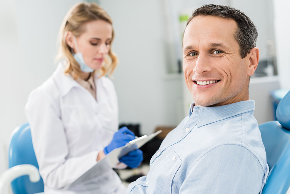 man smiling at the dentist