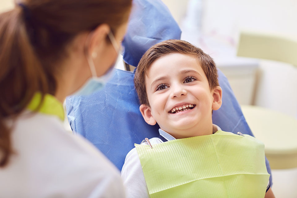 young boy sitting in the dental chair