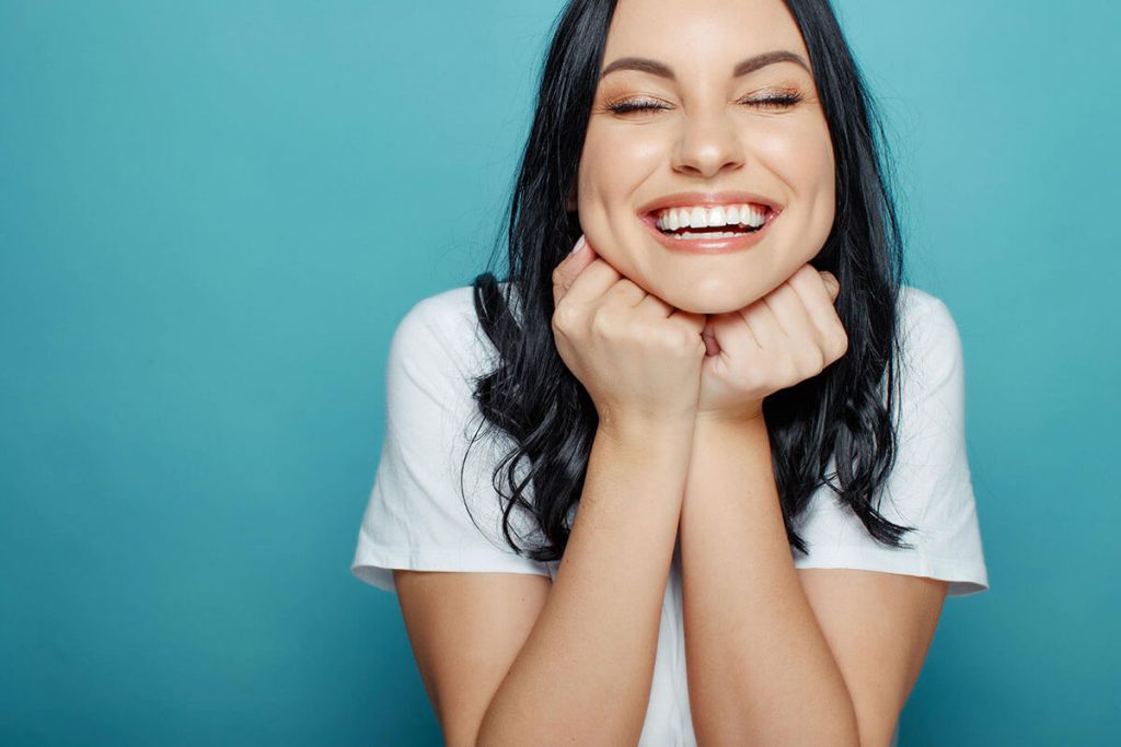 young lady showing off her smile after her dental filling treatment